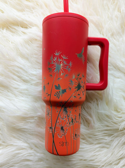 Dandelion "Blow Me" pattern engraved on peach and pink 40 oz insulated tumbler with handle by Simple Modern