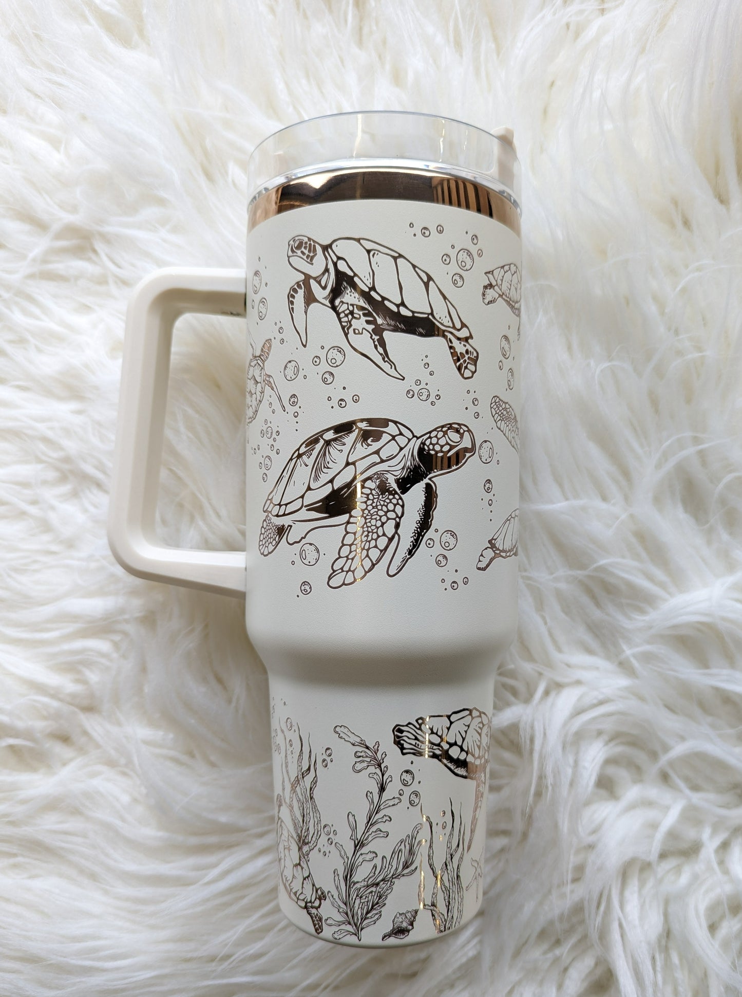 Photo collage of 40 oz cream/copper insulated tumbler with sea turtle oceanic design engraved