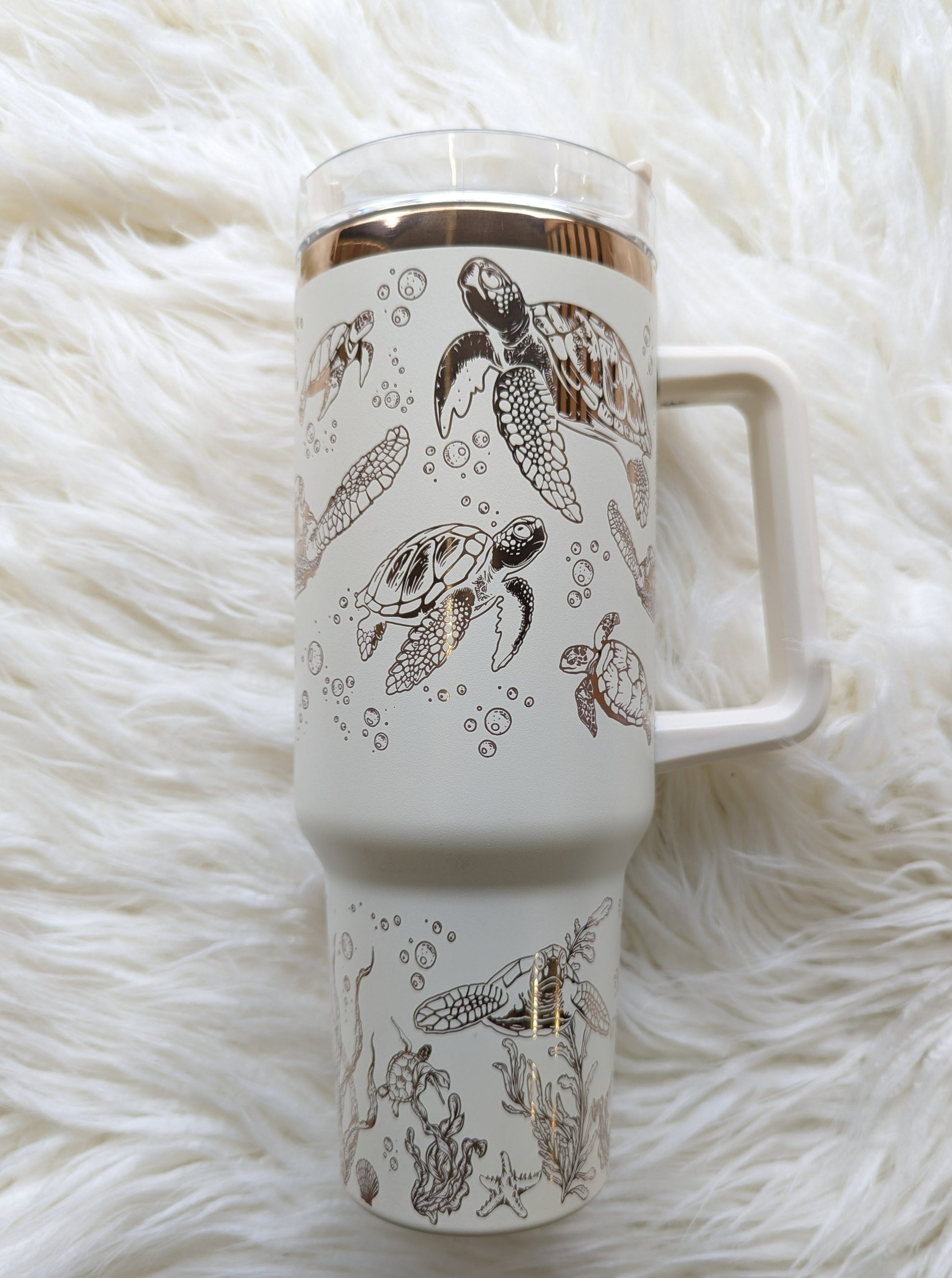 Photo  of 40 oz cream/copper insulated tumbler with sea turtle oceanic design engraved