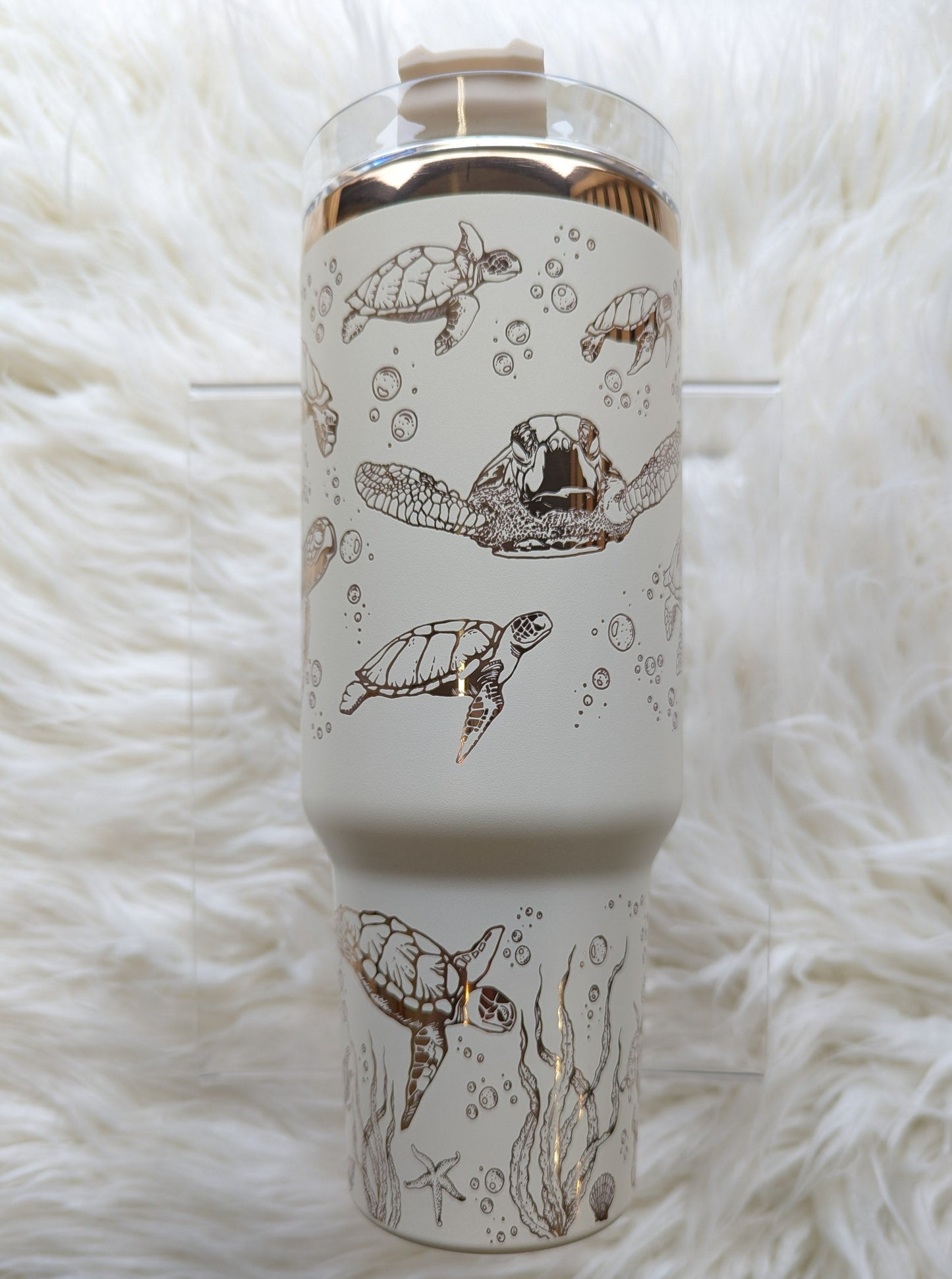 Photo collage of 40 oz cream/copper insulated tumbler with sea turtle oceanic design engraved