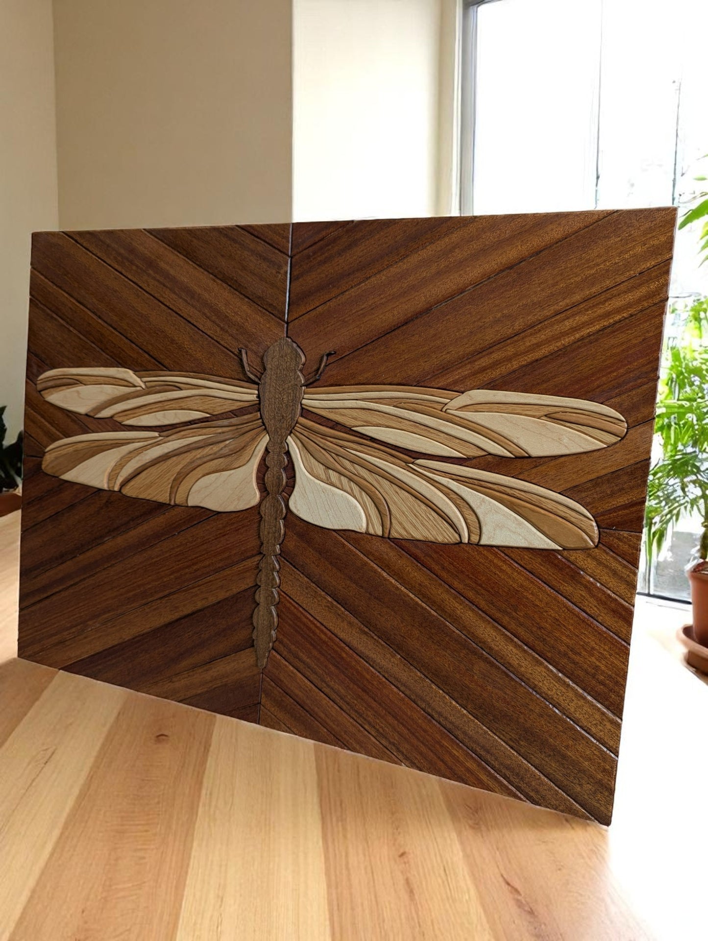 Angled view of handcrafted dragonfly wall art showing layered wood detail and maple edge banding.