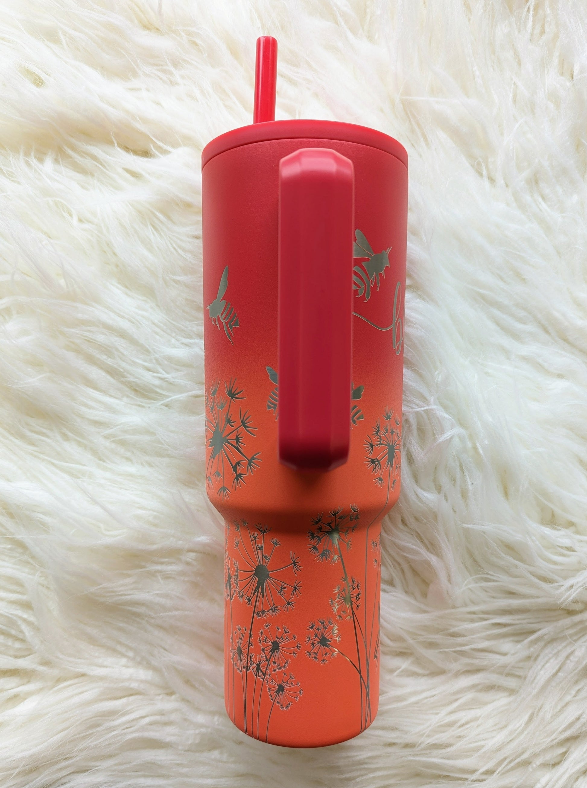 Dandelion "Blow Me" pattern engraved on peach and pink 40 oz insulated tumbler with handle by Simple Modern