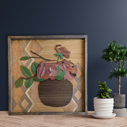 Laser Cut Wood Inlay wall art piece sitting on a table and leaning on a shelf with plants in the background.