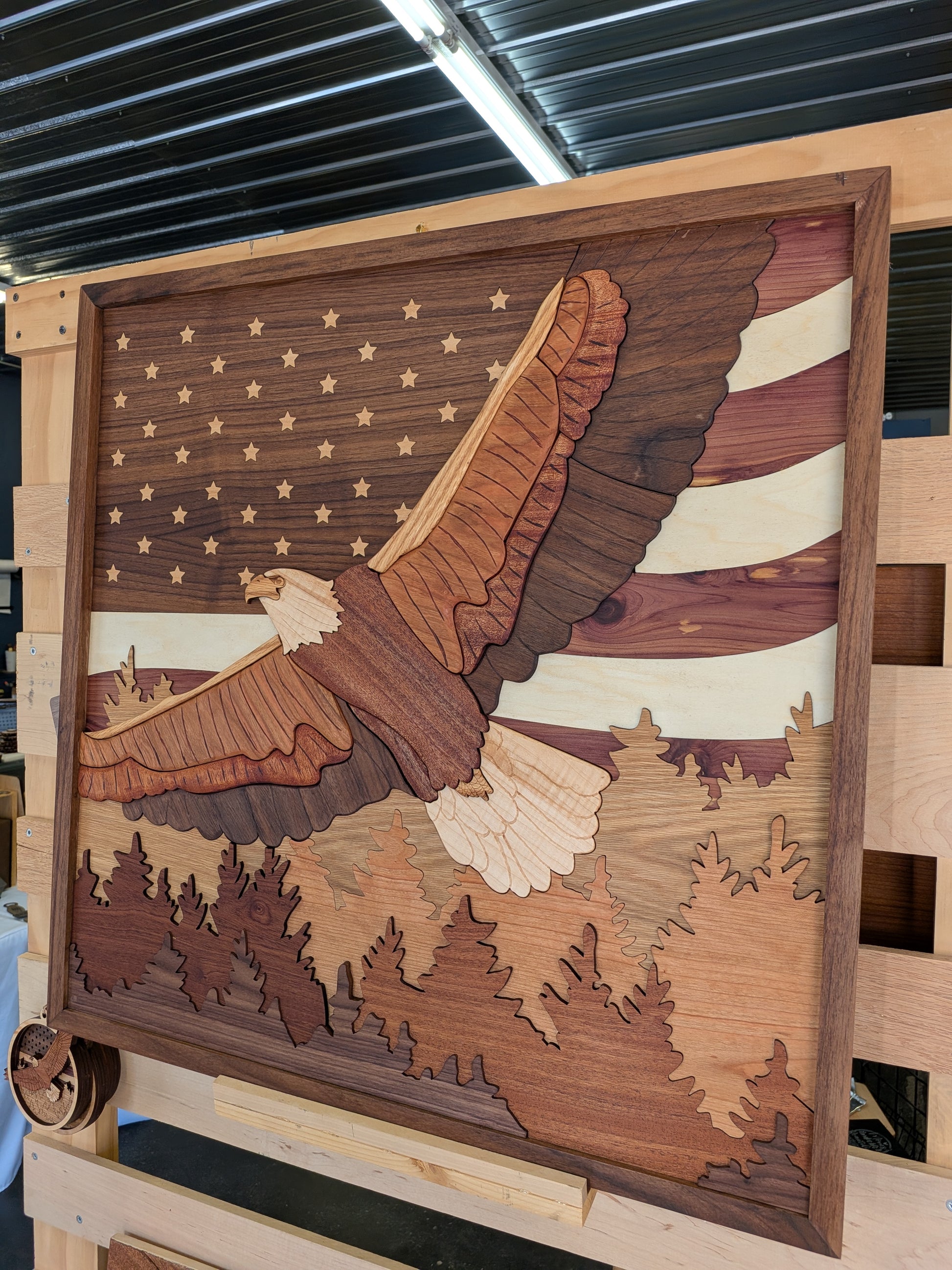 Wooden wall art with an eagle design on a background resembling the American flag.