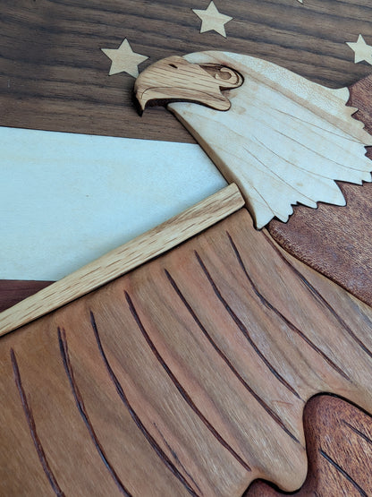 Wooden cutout of an eagle with outstretched wings on a wooden background