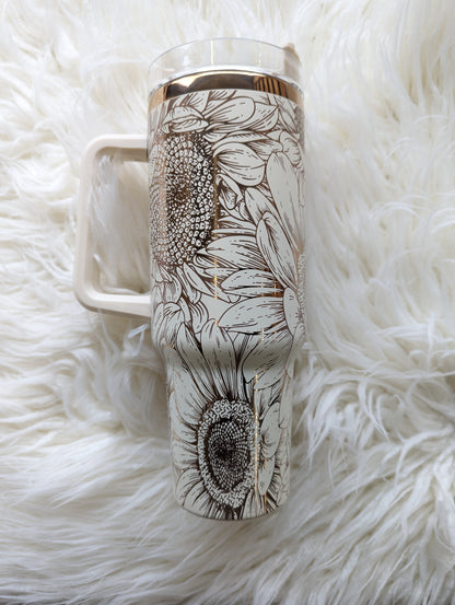 Photo of a 40 oz insulated tumbler with handle permanently engraved with a sunflower pattern and the text Mama Tried