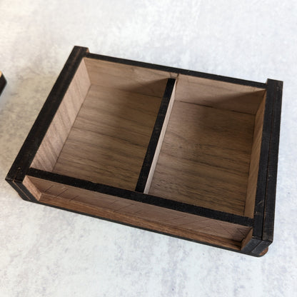 Interior view of handcrafted wooden playing card box with space for two decks of cards. Detailed woodwork on the inside and out.