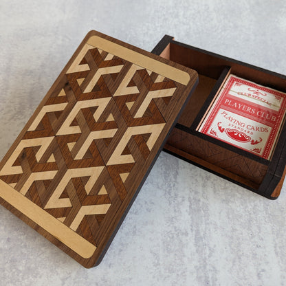 Handcrafted wooden playing card box made with layered cherry, walnut, maple, and mahogany veneer. Intricate geometric design on the lid with rich natural tones. Designed to hold two standard decks of cards.