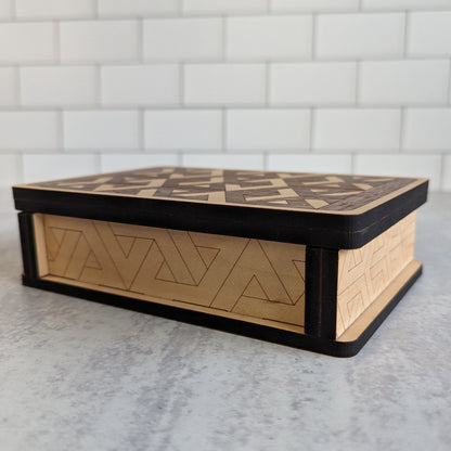 Handcrafted wooden playing card box made with layered cherry, walnut, maple, and mahogany veneer. Intricate geometric design on the lid with rich natural tones. Designed to hold two standard decks of cards.