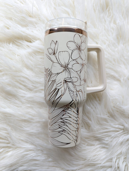 Photo is a 40 oz insulated tumbler in cream/copper engraved with a tropical flower pattern