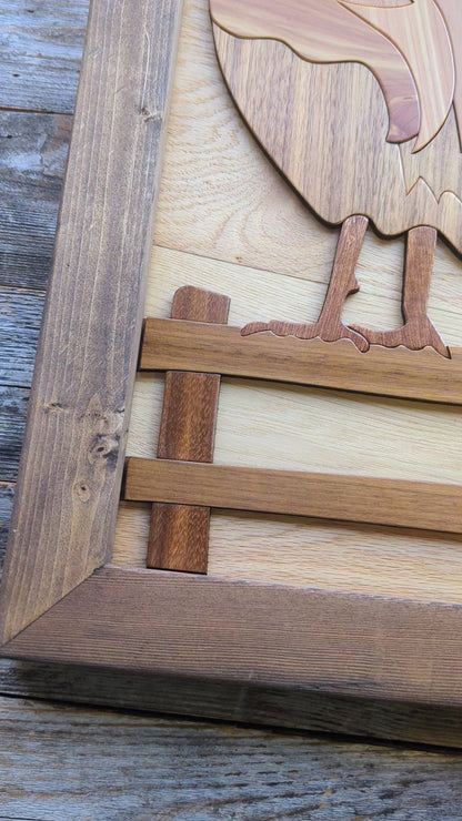 Video zooming in on the rooster’s foot on the wooden fence, highlighting detail and craftsmanship in the lower section.