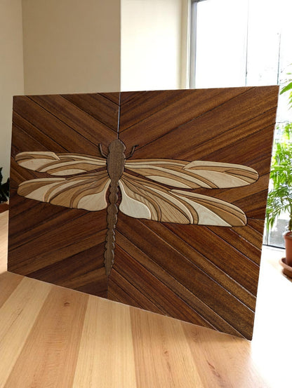 Angled view of handcrafted dragonfly wall art showing layered wood detail and maple edge banding.